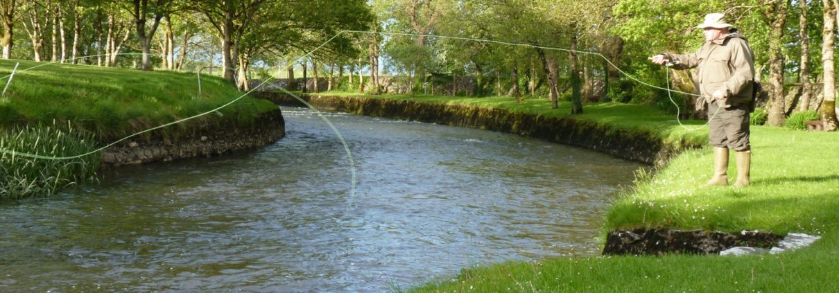 A fisherman Fly Fishing for trout on the River Clare at Milltown Co. Galway