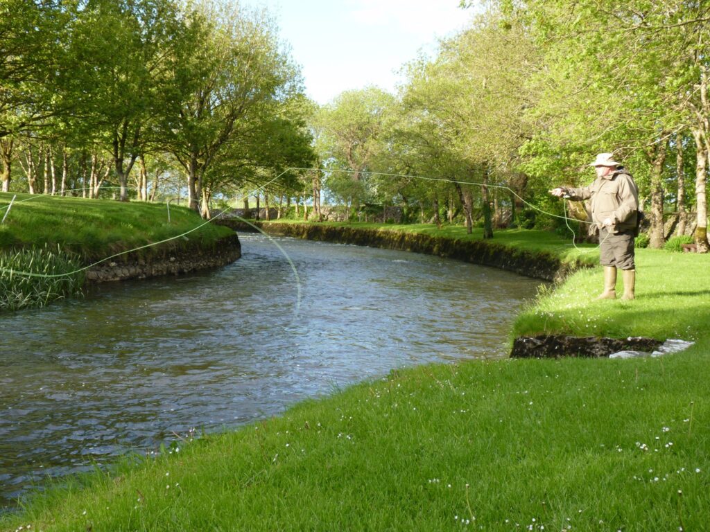 A fisherman Fly Fishing for trout on the River Clare at Milltown Co. Galway