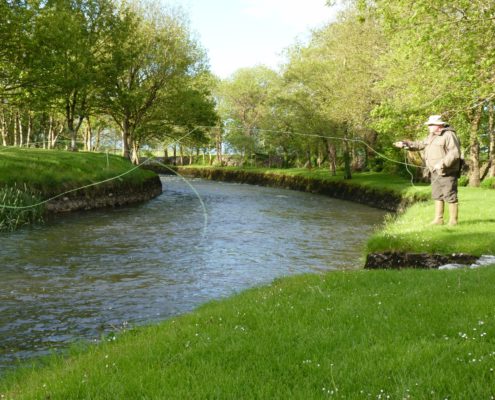 A fisherman Fly Fishing for trout on the River Clare at Milltown Co. Galway