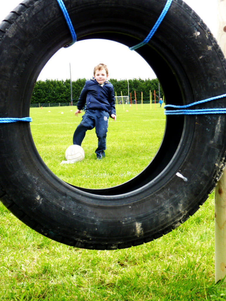 Playing football in Milltown GAA Grounds